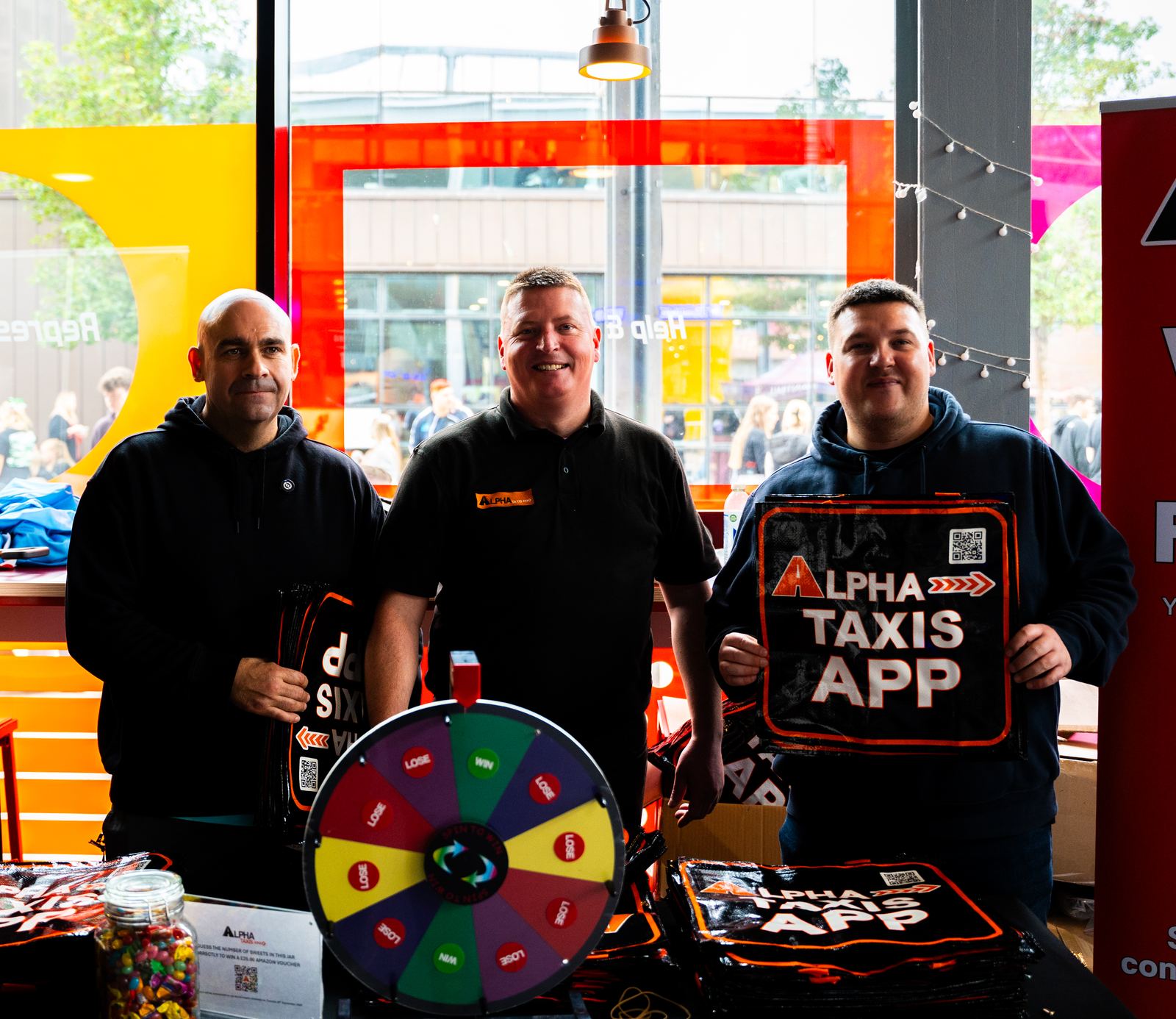 The Alpha Taxis team promoting the Alpha Taxis app at a local event